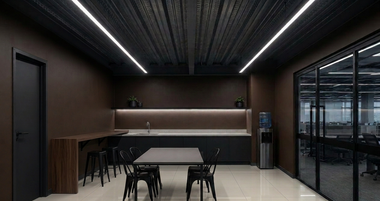 OmniXela pantry and breakroom with an L-shaped wall bar, gray table, sink and water chiller